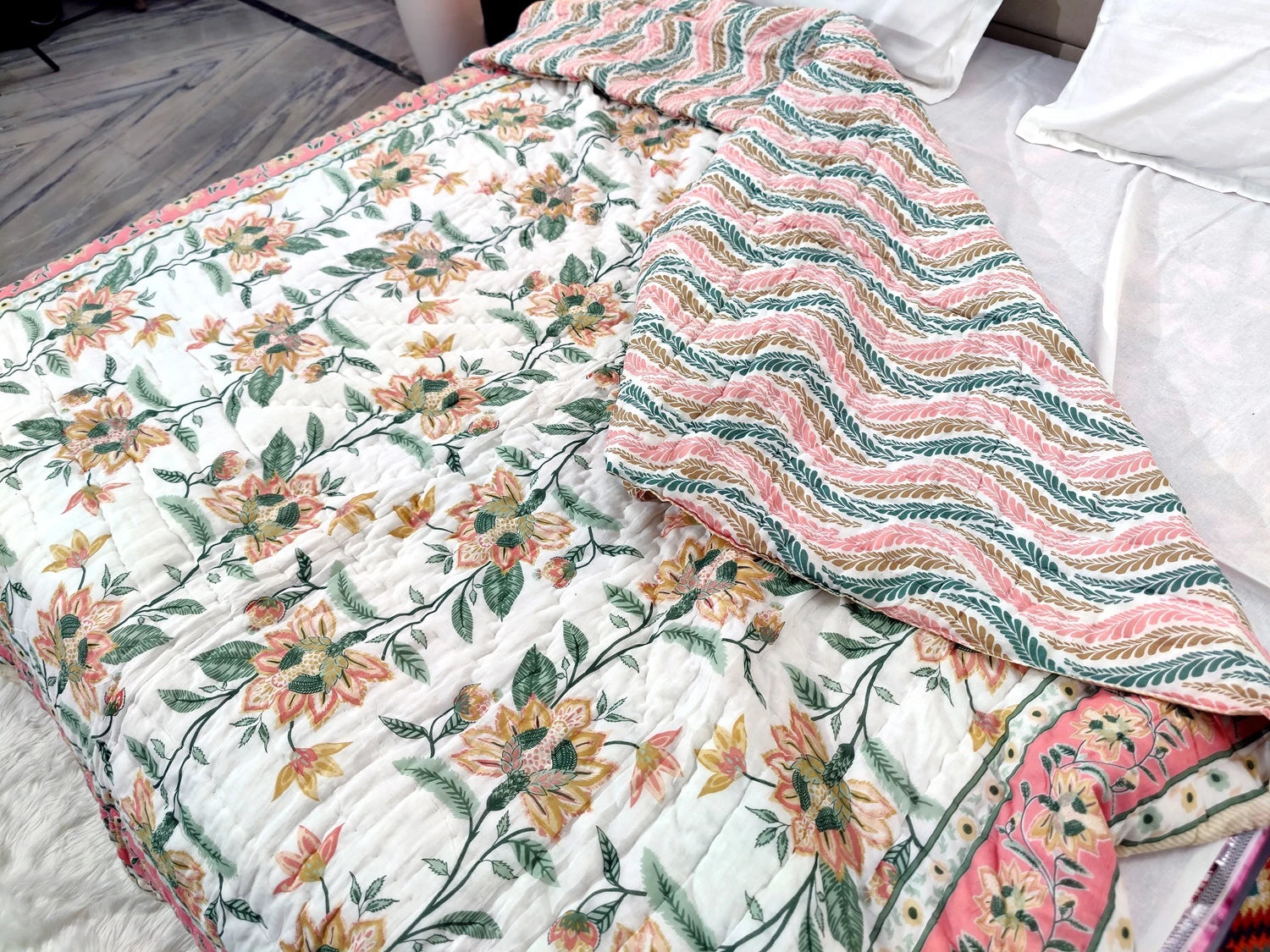 Jaipuri cotton quilt double bed featuring colorful floral design on one side and wavy pattern on the other